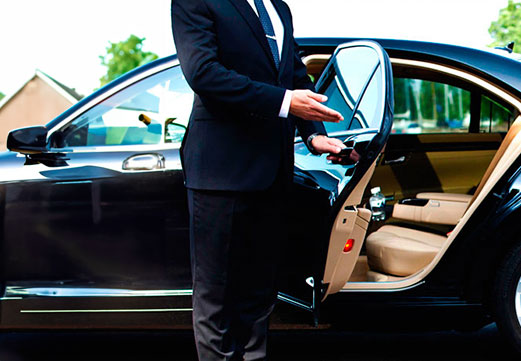 Professional Cars Executive chauffeur assisting a VIP client in Surrey.